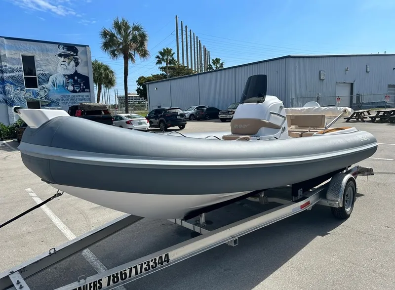 Slide: The Image of 2023 2 Bar 6.20 inflatable boat on a trailer in a parking lot. - 4