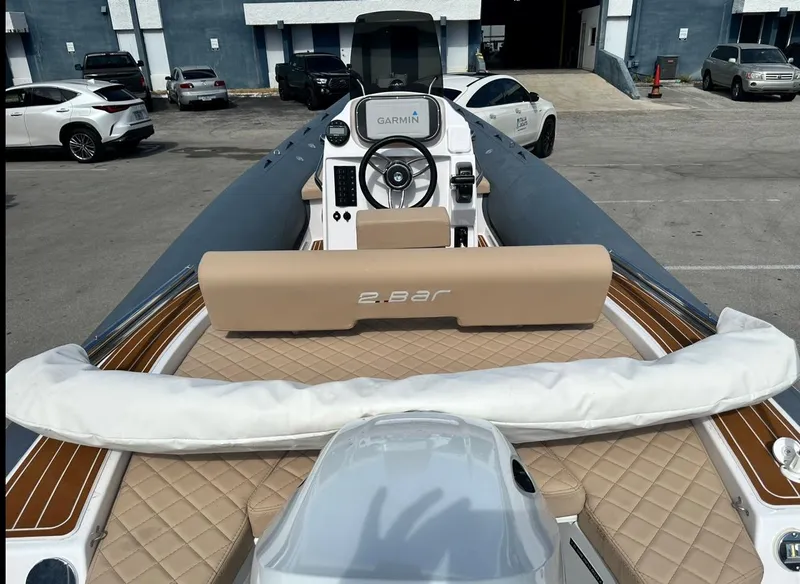 Slide: The Image of 2023 2 Bar 6.20 boat with tan seating and Garmin navigation system. - 7