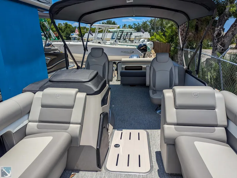 Slide: The Image of 2024 Premier 230 Sunsation RE pontoon boat interior with luxurious seating and canopy. - 11