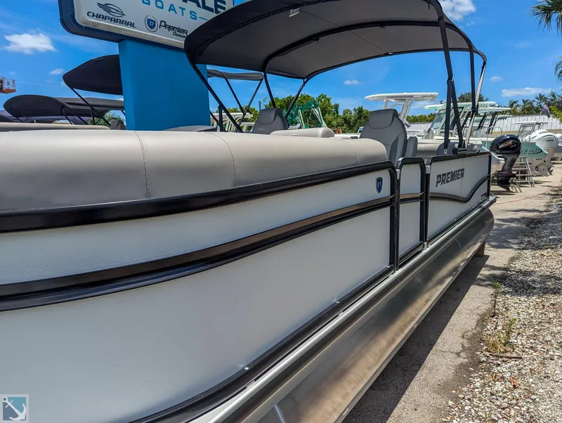 Slide: The Image of 2024 Premier 230 Sunsation RE pontoon boat at a dealership. - 2