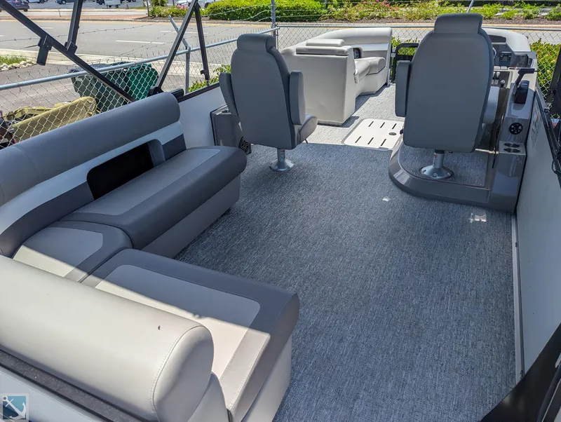 Slide: The Image of 2024 Premier 230 Sunsation RE pontoon boat interior with gray seating and carpet. - 3