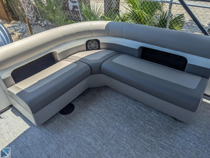 Slide: The Image of 2024 Premier 230 Sunsation RE boat with luxurious gray seating and built-in speaker. - 4