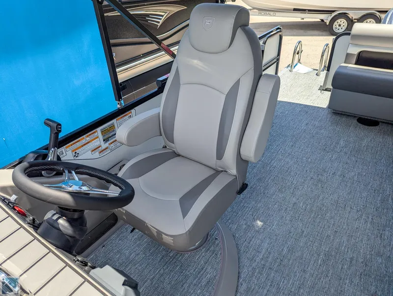 Slide: The Image of 2024 Premier 230 Sunsation RE boat captain's chair and steering wheel. - 6
