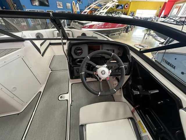 Slide: The Image of 2024 Yamaha Boats SX195 interior view with seating and steering console. - 10