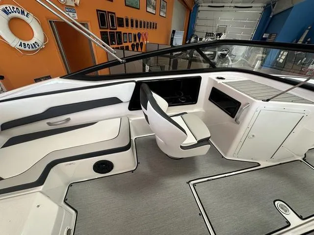 Slide: The Image of 2024 Yamaha SX195 boat interior with sleek seating and modern dashboard design. - 11