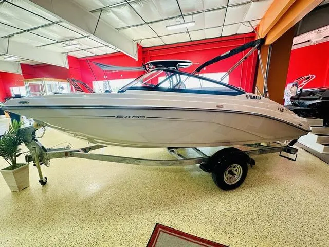Slide: The Image of 2024 Yamaha Boats SX195 interior, spacious seating, modern design, docked at marina. - 5