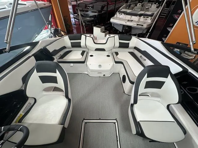 Slide: The Image of 2024 Yamaha Boats SX195 on trailer, parked outdoors near a building. - 9