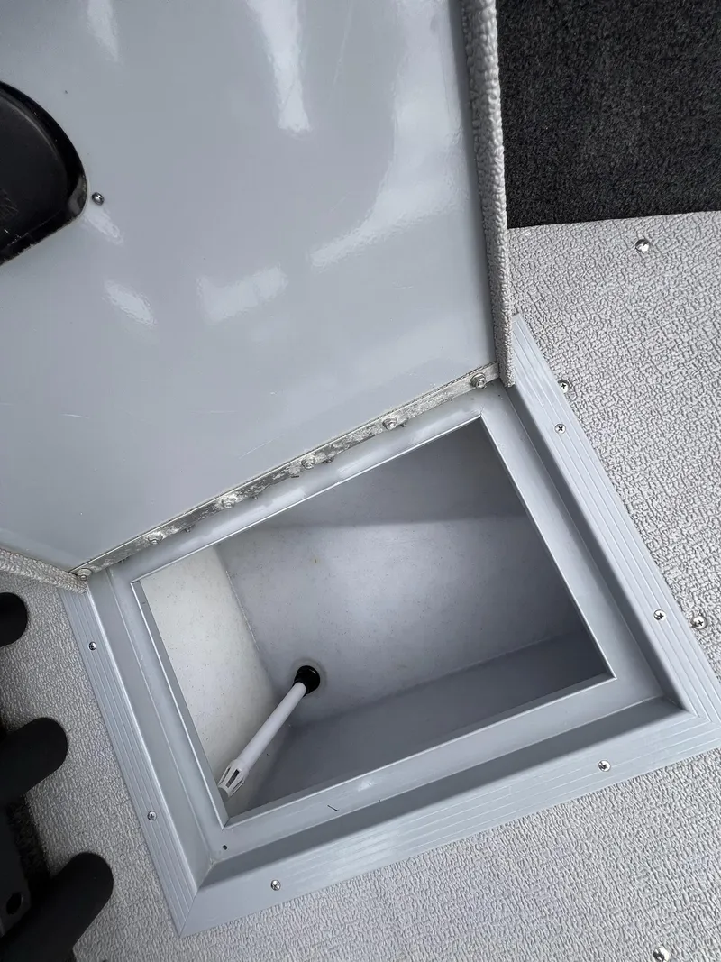 Slide: The Image of Open storage compartment in 2024 Starcraft Renegade 168 DC boat. - 12
