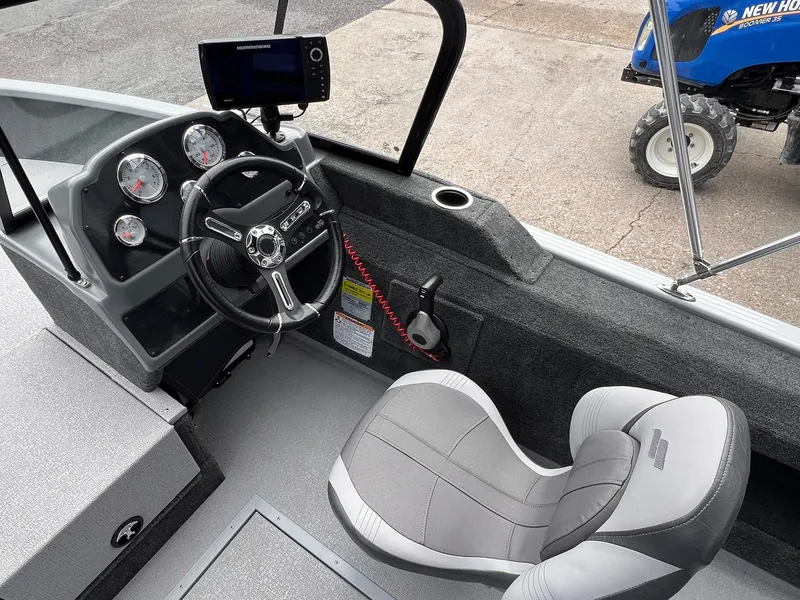 Slide: The Image of 2024 Starcraft Renegade 168 DC boat interior with steering wheel and dashboard controls. - 13