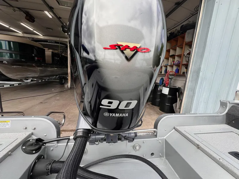 Slide: The Image of 2024 Starcraft Renegade 168 DC with Yamaha 90 outboard motor in a garage setting. - 17