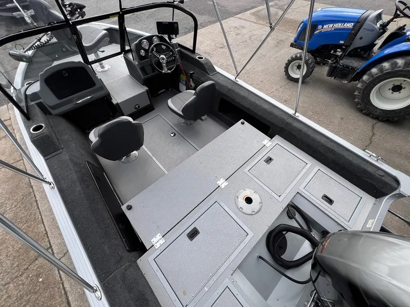 Slide: The Image of 2024 Starcraft Renegade 168 DC boat interior with seating and control panel. - 21