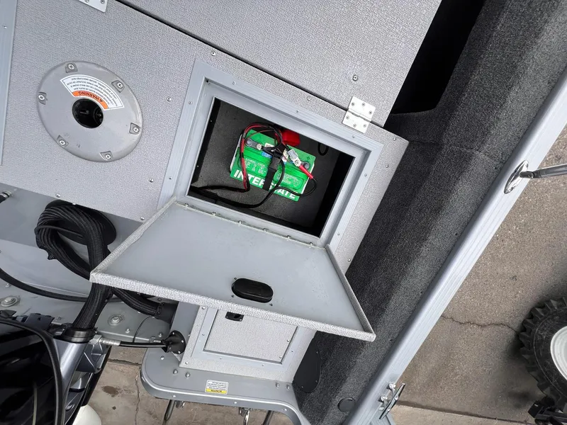 Slide: The Image of 2024 Starcraft Renegade 168 DC boat battery compartment with open hatch and visible wiring. - 22