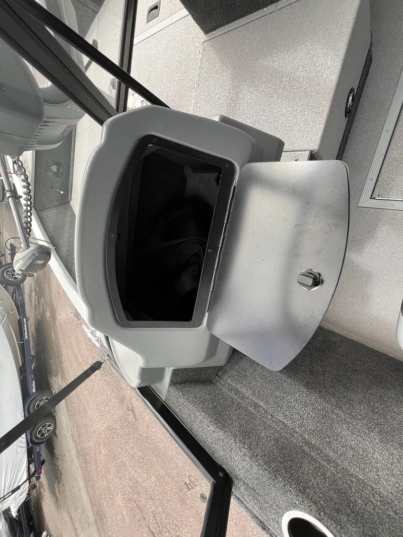 Slide: The Image of 2024 Starcraft Renegade 168 DC boat interior with open storage compartment. - 23