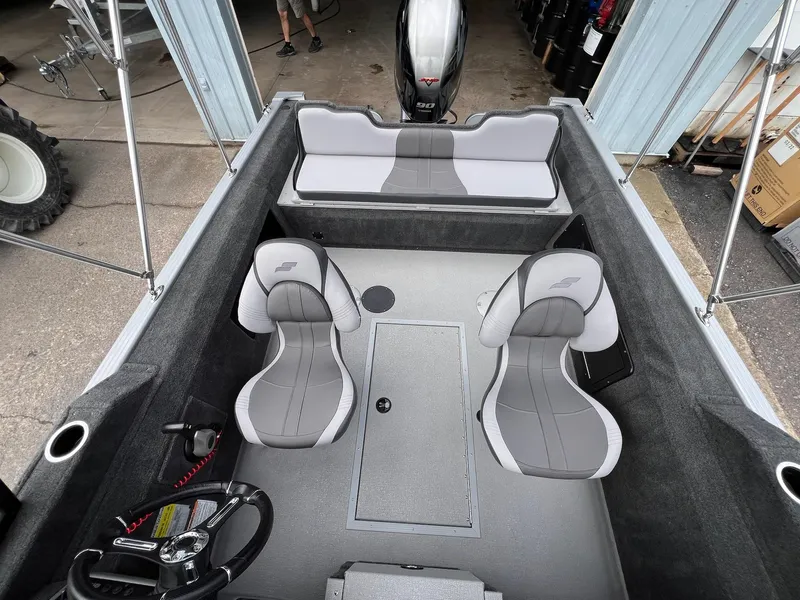 Slide: The Image of 2024 Starcraft Renegade 168 DC boat interior with gray seating and steering wheel. - 24
