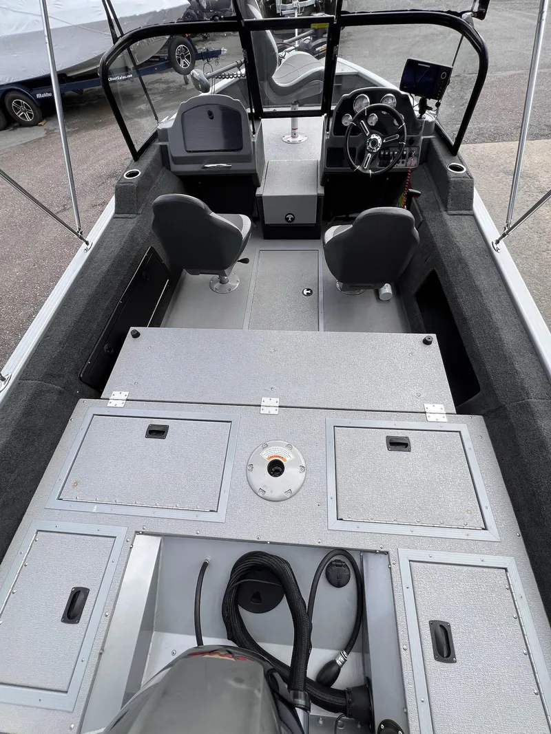 Slide: The Image of 2024 Starcraft Renegade 168 DC boat interior with dual consoles and seating. - 25