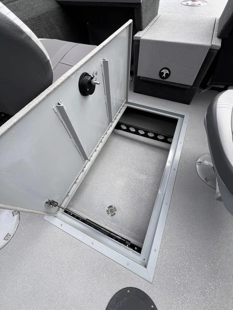 Slide: The Image of 2024 Starcraft Renegade 168 DC boat interior storage compartment open. - 26