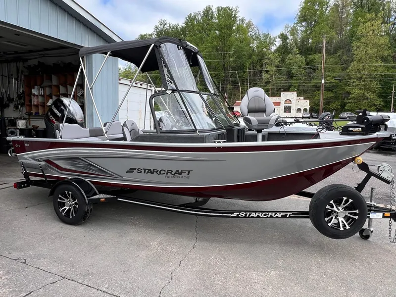 Slide: The Image of 2024 Starcraft Renegade 168 DC boat on trailer, parked outdoors near a garage. - 28