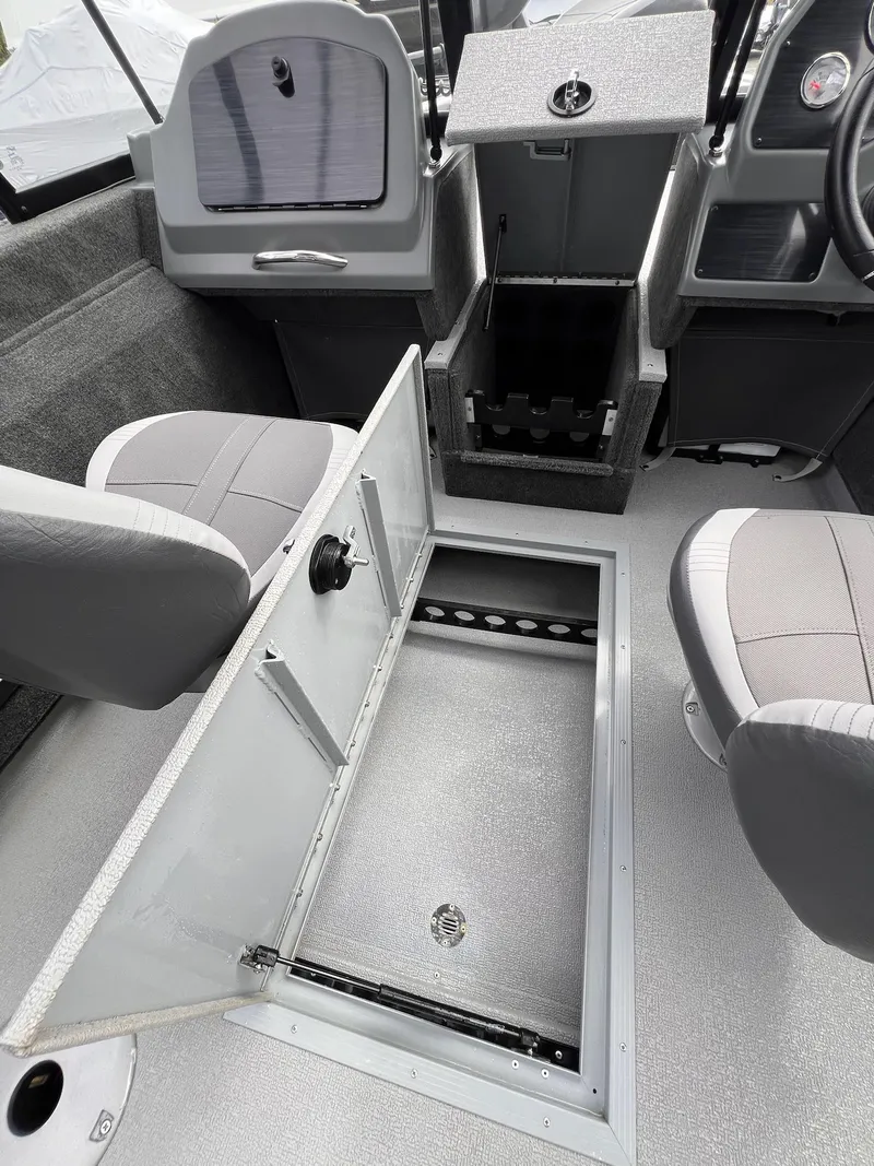 Slide: The Image of 2024 Starcraft Renegade 168 DC boat interior with open storage compartment and seating. - 33