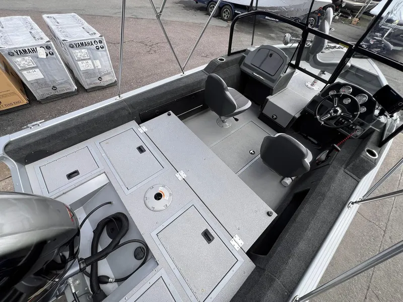 Slide: The Image of 2024 Starcraft Renegade 168 DC boat interior with dual seats and Yamaha engine packaging. - 34