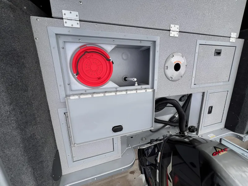 Slide: The Image of 2024 Starcraft Renegade 168 DC boat interior storage compartments and engine detail. - 5