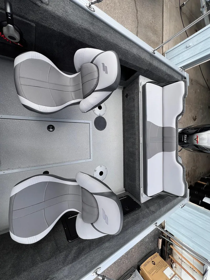 Slide: The Image of 2024 Starcraft Renegade 168 DC boat interior with gray seating and storage compartments. - 6
