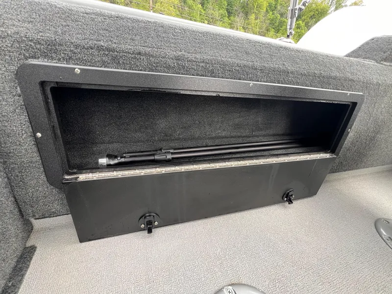 Slide: The Image of 2024 Starcraft Renegade 168 DC boat storage compartment with fishing rod inside. - 7