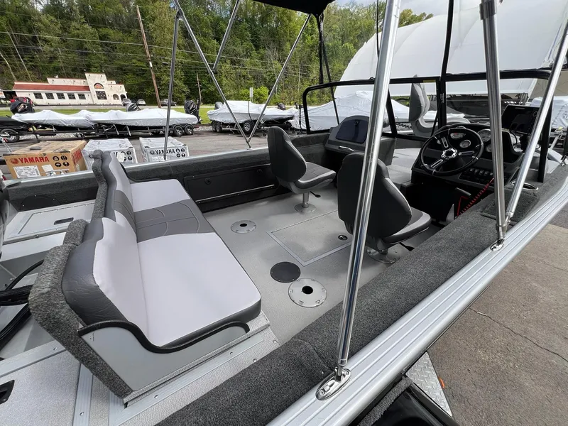 Slide: The Image of 2024 Starcraft Renegade 168 DC boat interior with seating and steering console. - 8