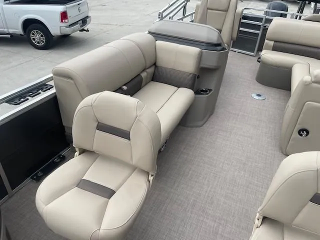 Slide: The Image of 2024 Sun Tracker Fishin' Barge 20 DLX interior with beige seating and spacious layout. - 10