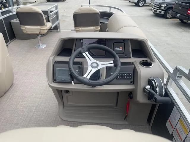 Slide: The Image of 2024 Sun Tracker Fishin' Barge 20 DLX pontoon boat helm with steering wheel and controls. - 13