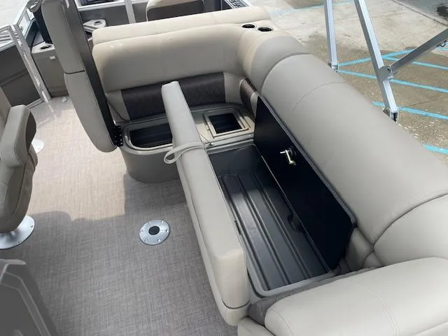 Slide: The Image of 2024 Sun Tracker Fishin' Barge 20 DLX interior seating and storage compartments. - 14