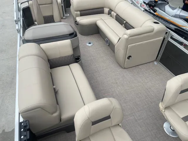 Slide: The Image of 2024 Sun Tracker Fishin' Barge 20 DLX interior with beige seating and spacious layout. - 9