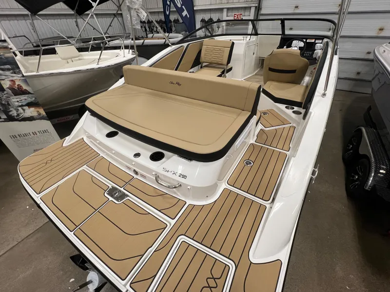 Slide: The Image of 2024 Sea Ray SPX 210 boat with tan seating and deck in showroom. - 4