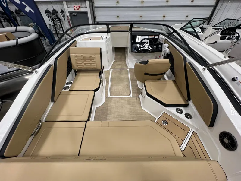 Slide: The Image of 2024 Sea Ray SPX 210 boat interior with tan seating and modern dashboard. - 5