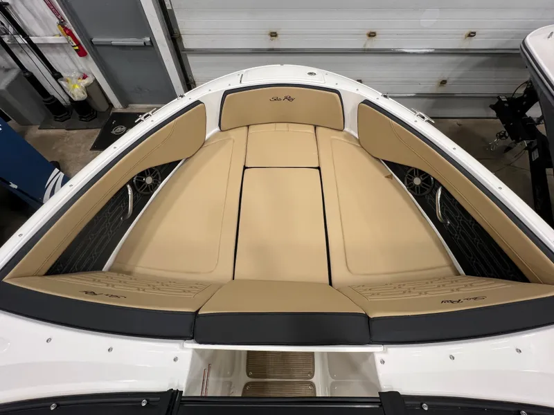 Slide: The Image of 2024 Sea Ray SPX 210 boat interior with tan seating and black accents. - 7