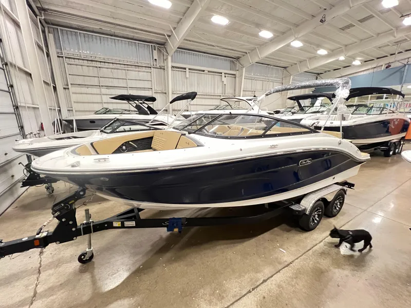 Slide: The Image of 2024 Sea Ray SPX 210 boat in showroom with trailer. - 9