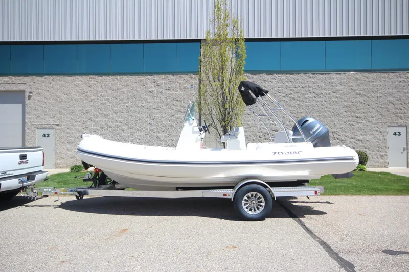 The Image of 2025 Zodiac Medline 5.8 NEO boat on trailer, parked outdoors. - 0
