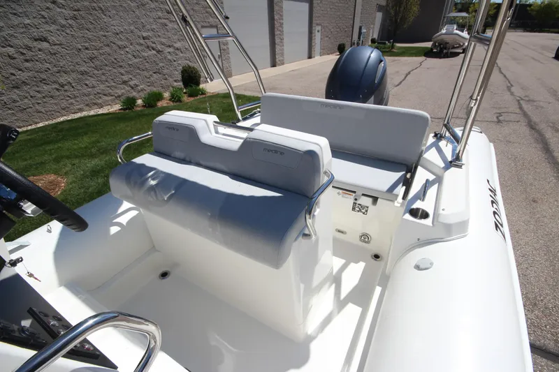 Slide: The Image of 2025 Zodiac Medline 5.8 NEO boat interior with seating and steering, parked outdoors. - 15