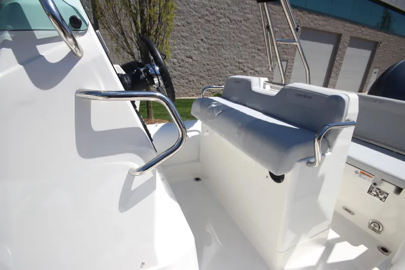 Slide: The Image of 2025 Zodiac Medline 5.8 NEO boat interior with steering wheel and cushioned seating. - 18