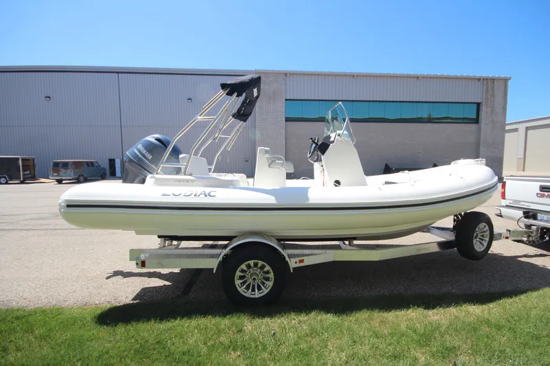 Slide: The Image of 2025 Zodiac Medline 5.8 NEO boat on trailer, parked outdoors. - 2