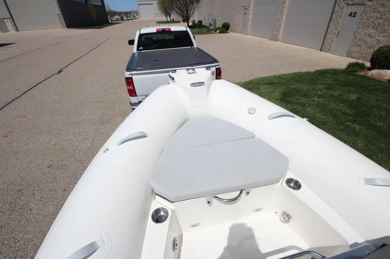 Slide: The Image of 2025 Zodiac Medline 5.8 NEO boat on trailer, parked near a white truck. - 8