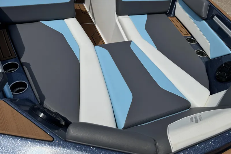 Slide: The Image of 2024 ATX Surf Boats 24 Type-S interior with blue and gray seating, cup holders. - 24