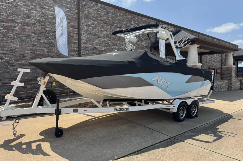 Slide: The Image of 2024 ATX Surf Boats 24 Type-S on trailer, covered, parked outdoors. - 26