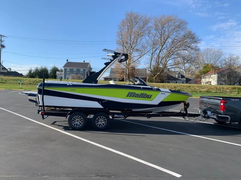 Slide: The Image of 2024 Malibu LX-R boat on trailer in parking lot. - 10