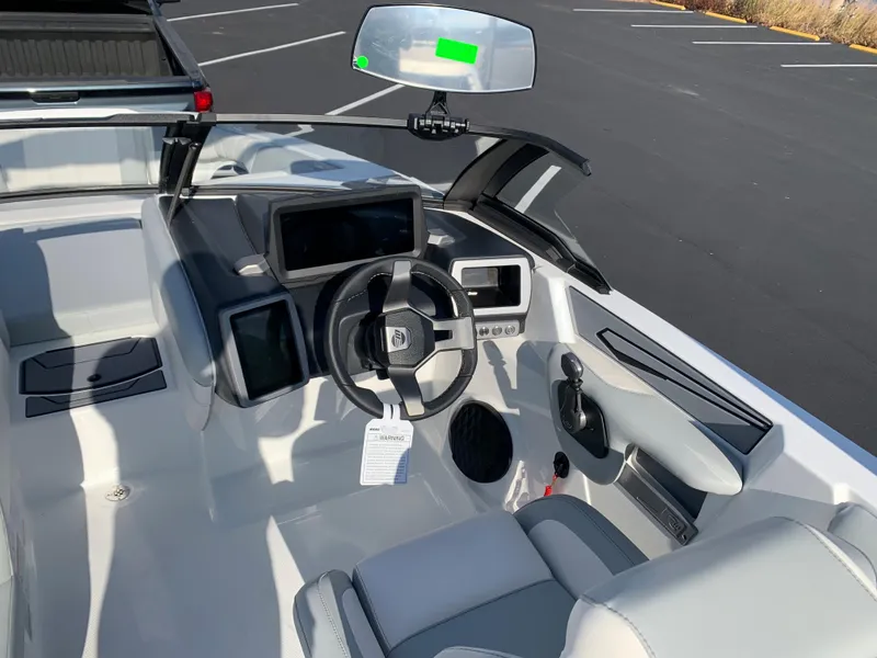 Slide: The Image of 2024 Malibu LX-R boat cockpit with modern steering wheel and digital displays. - 14
