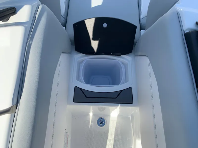 Slide: The Image of 2024 Malibu LX-R boat interior with storage compartment and cup holder. - 2