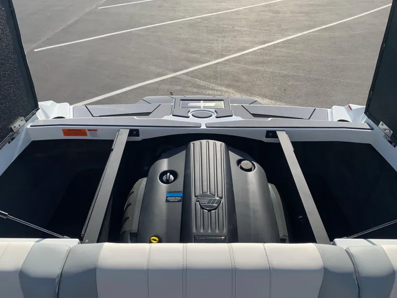 Slide: The Image of 2024 Malibu LX-R boat engine compartment in a parking lot. - 6