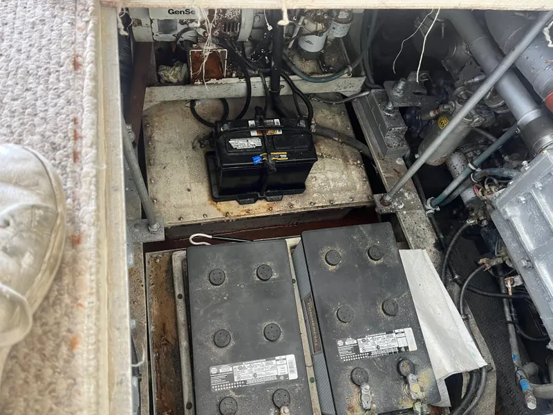 Slide: The Image of Engine compartment of a 1988 Trojan 12 Meter Convertible boat with visible batteries. - 27