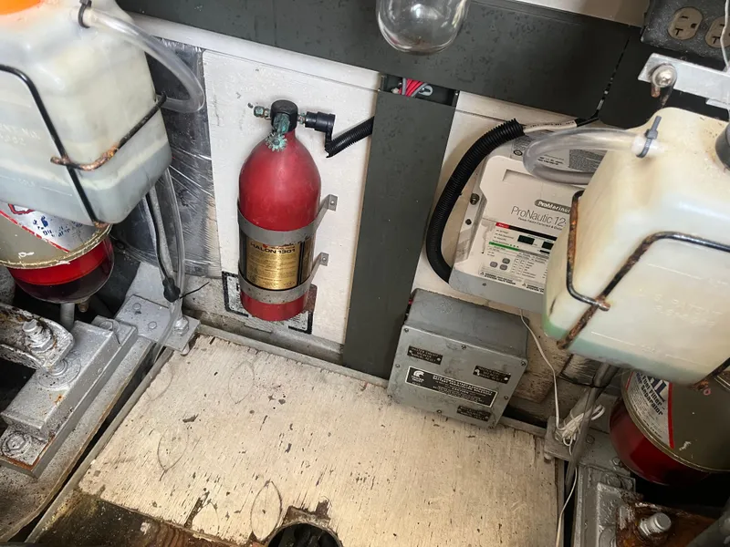 Slide: The Image of Engine compartment of a 1988 Trojan 12 Meter Convertible with fire extinguisher and control panel. - 29