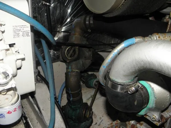 Slide: The Image of Engine room of a 1988 Trojan 12 Meter Convertible boat showing pipes and machinery. - 18