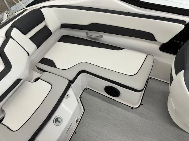 Slide: The Image of 2024 Yamaha Boats SX195 interior seating with sleek black and white design. - 10